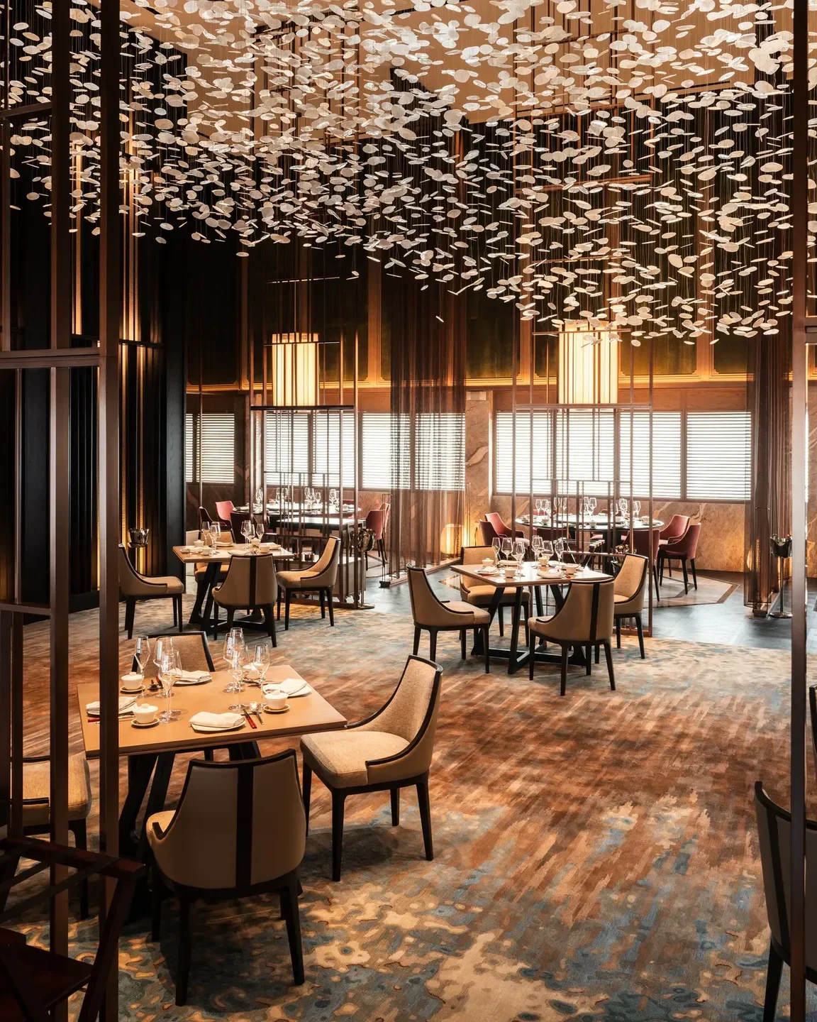 Elegant interior of Shisen Hanten restaurant in Singapore, showcasing stylish dining tables and lighting.