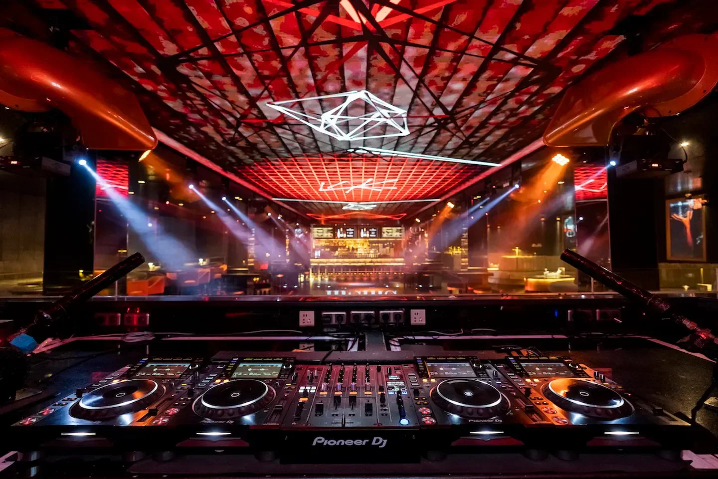 Inside ShiShi Bali nightclub in Bali with DJ setup and stage lights.