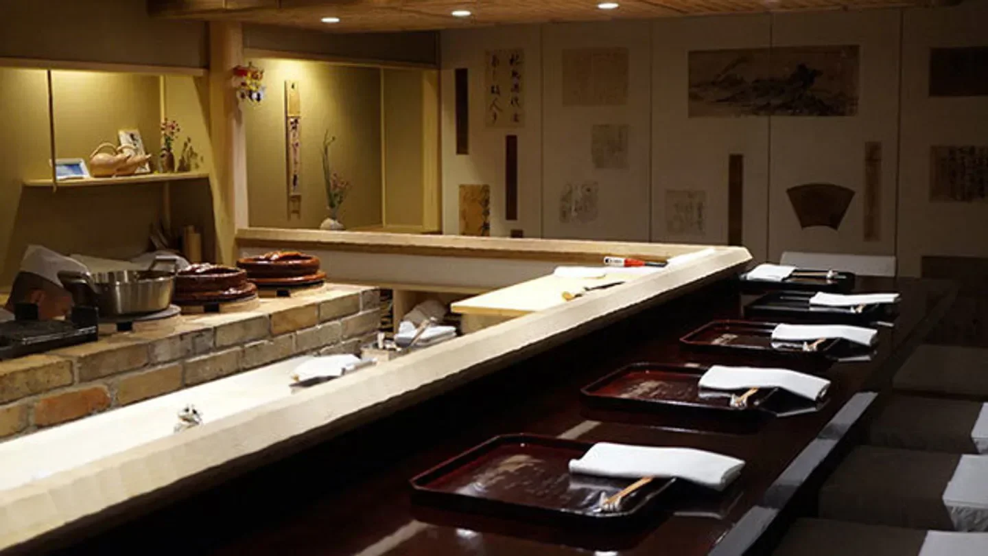 Interior of Shokuzen Abe in Tokyo with counter seating and sushi preparation area.