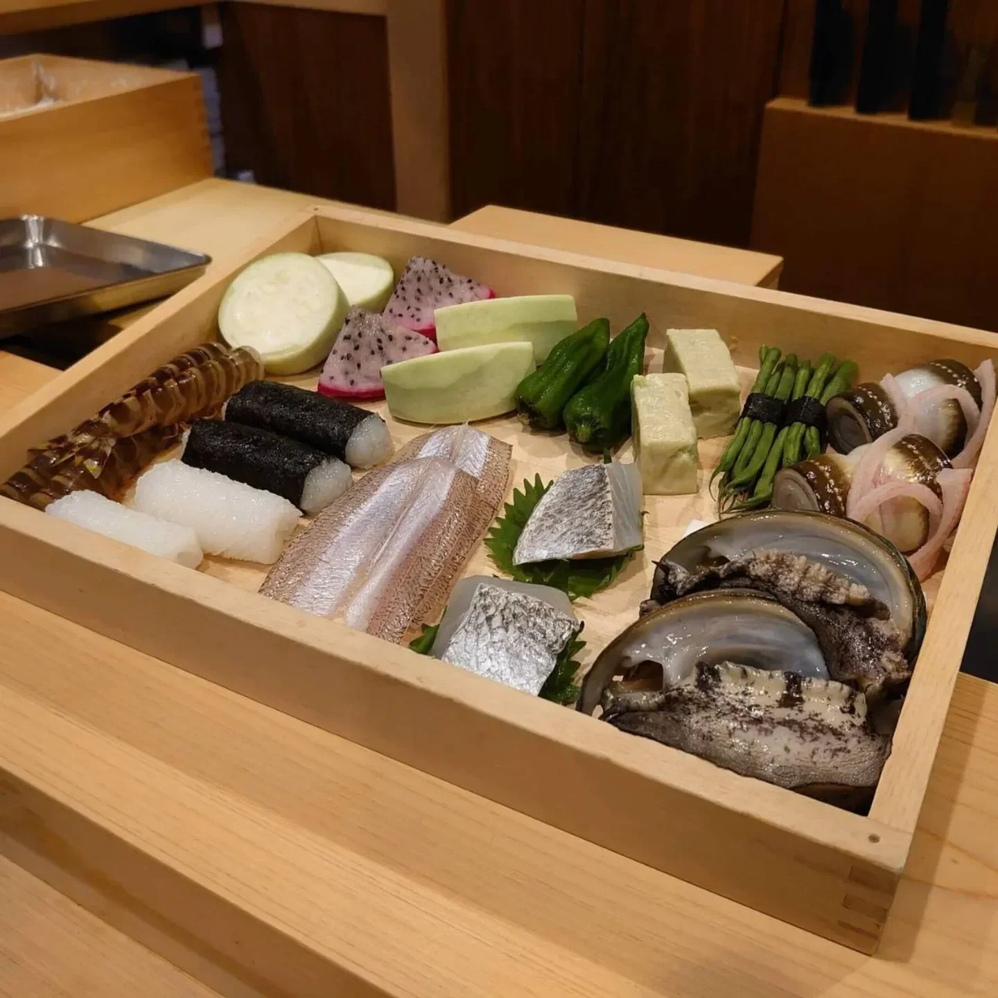 Delicious assortment of fresh seafood and vegetables at Shunkeian Arakaki restaurant in Tokyo.