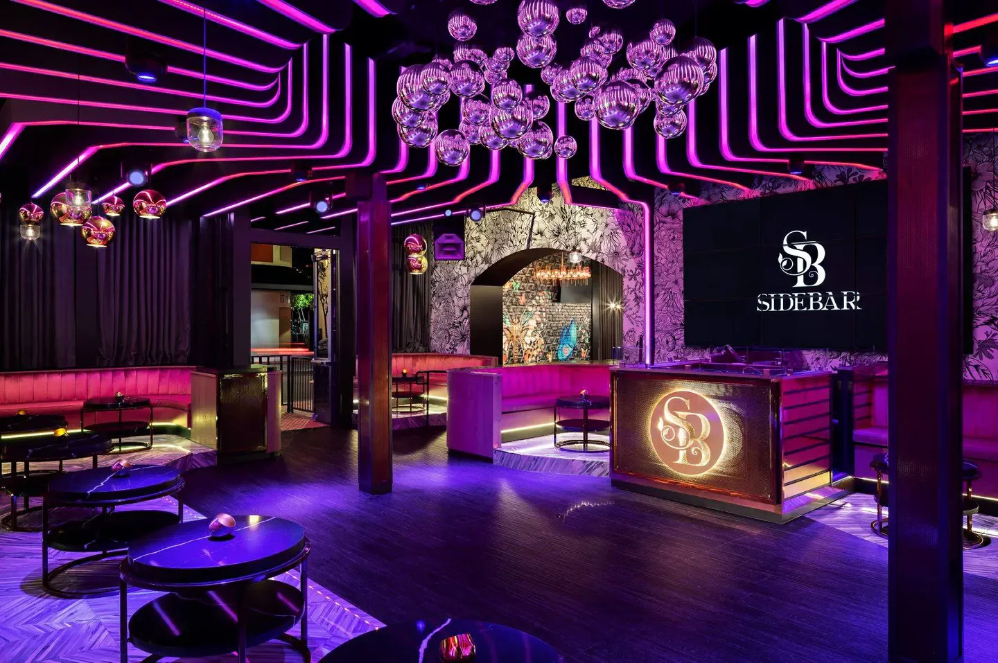 Interior of Side Bar nightclub in San Diego with purple neon lighting and decor
