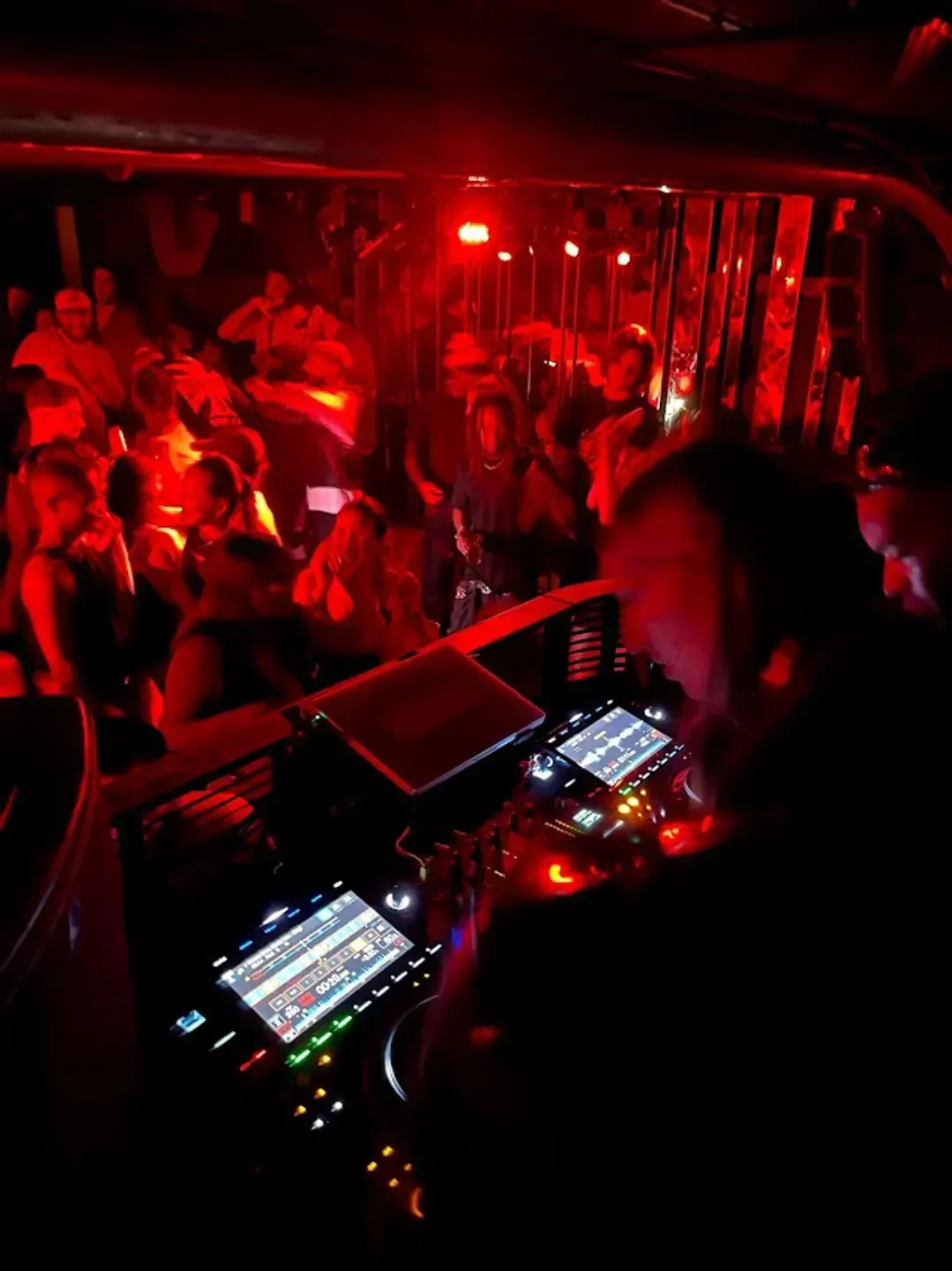DJ set at Silencio nightclub in Paris, with a red-lit dance floor and crowd.