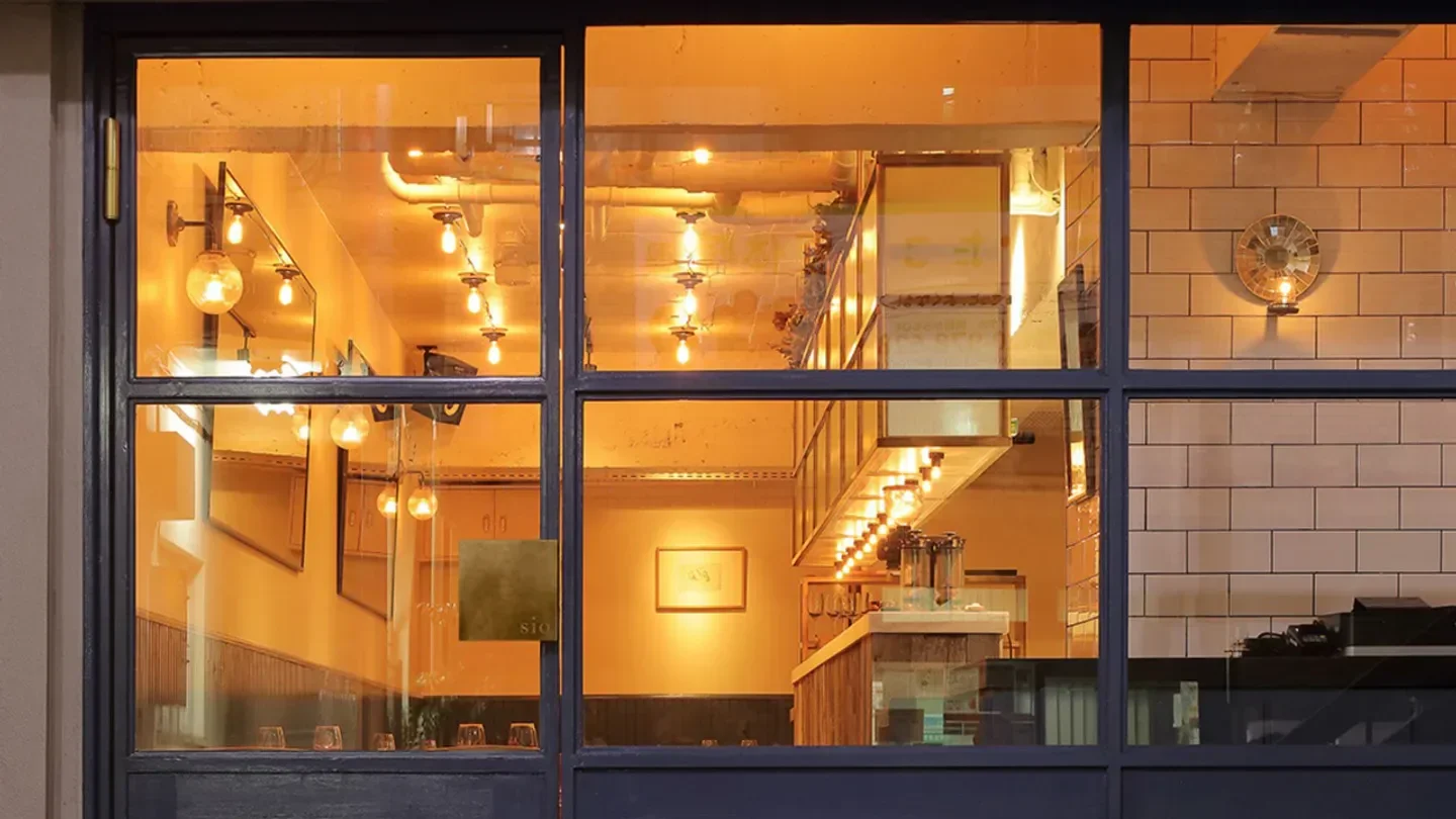 Warm interior view of sio restaurant in Tokyo, showcasing elegant lighting and design.