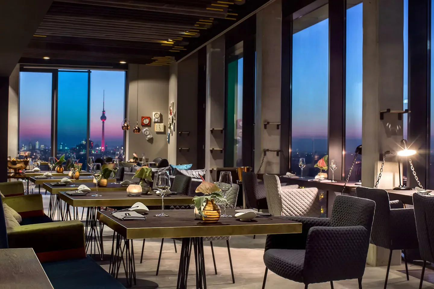 SKYKITCHEN restaurant in Berlin, with city views and elegant dining tables.