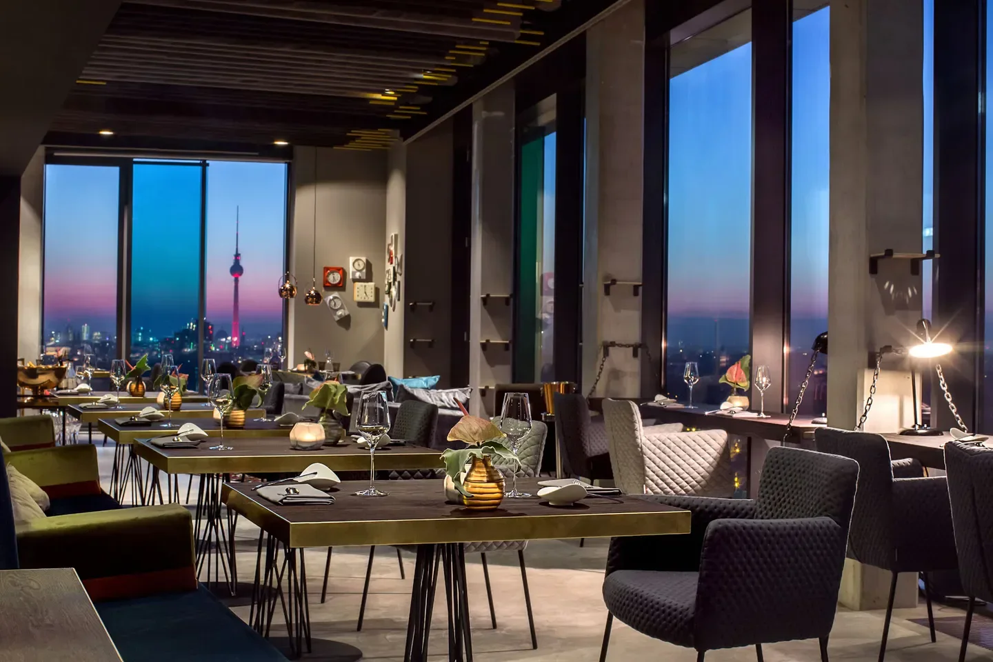 SKYKITCHEN restaurant in Berlin, with city views and elegant dining tables.