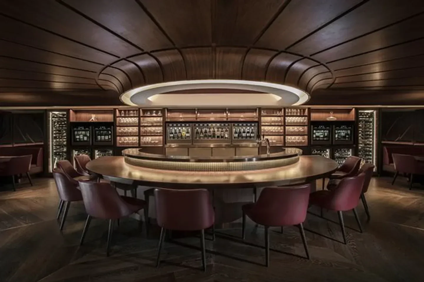 Interior of SOMM in Hong Kong, featuring a stylish bar with seating and wine display.