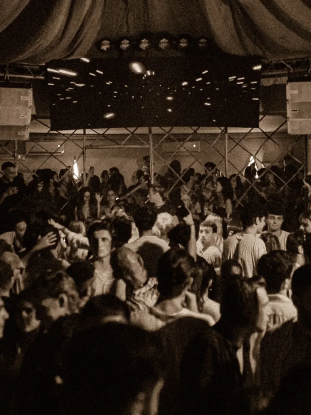 Energetic crowd dancing at Sopravento Club in Porto Cervo under disco lights