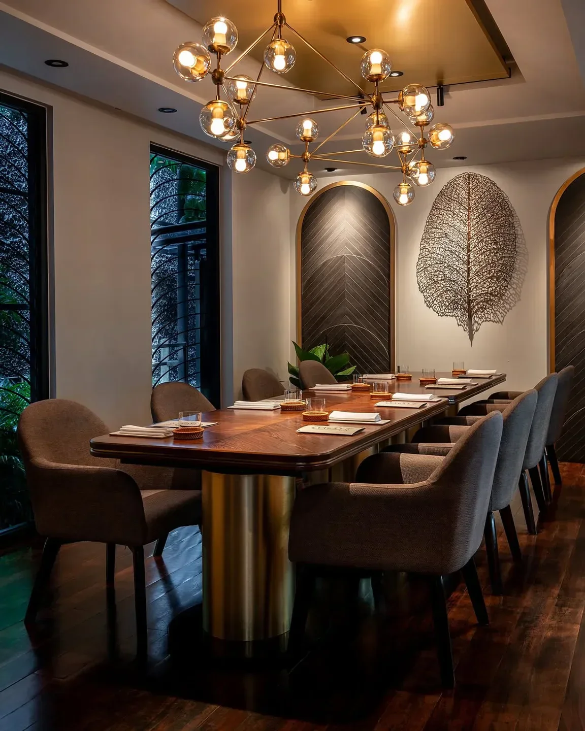 Elegant dining room at Sorn restaurant in Bangkok, featuring stylish lighting and decor.