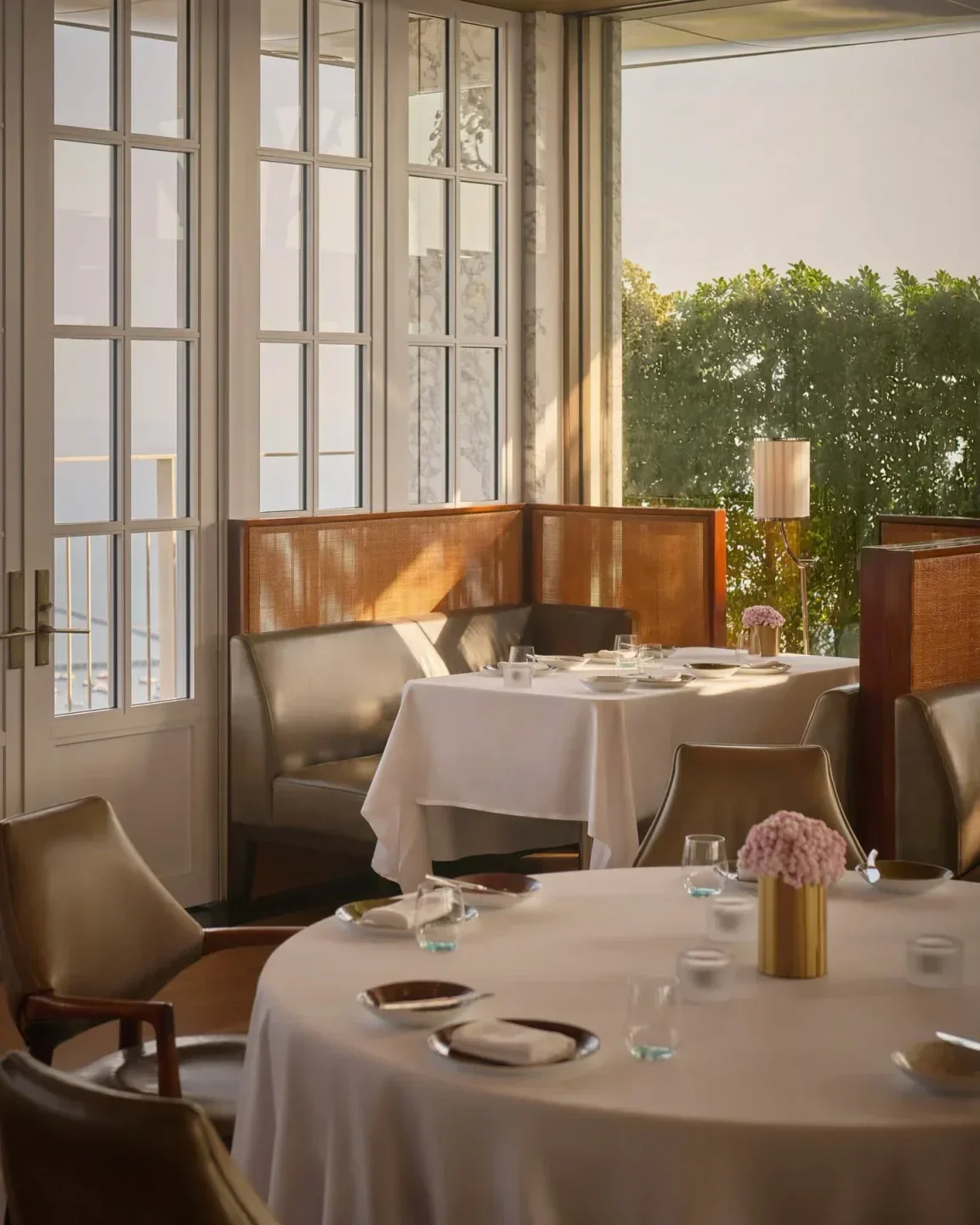 Elegant dining room interior at Spago Singapore, featuring tables set for dinner.