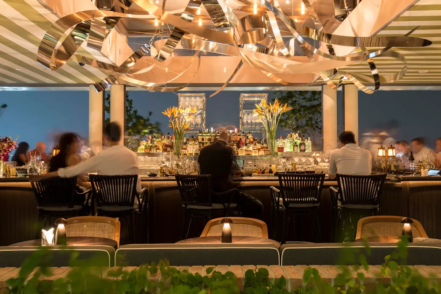 Stylish bar at Spago Singapore with patrons enjoying a night out in Singapore.