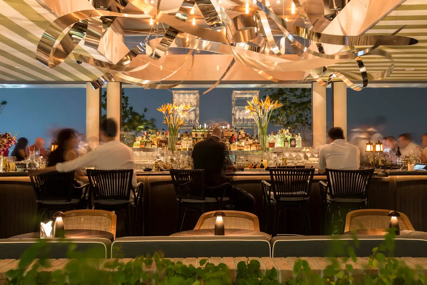 Stylish bar at Spago Singapore with patrons enjoying a night out in Singapore.