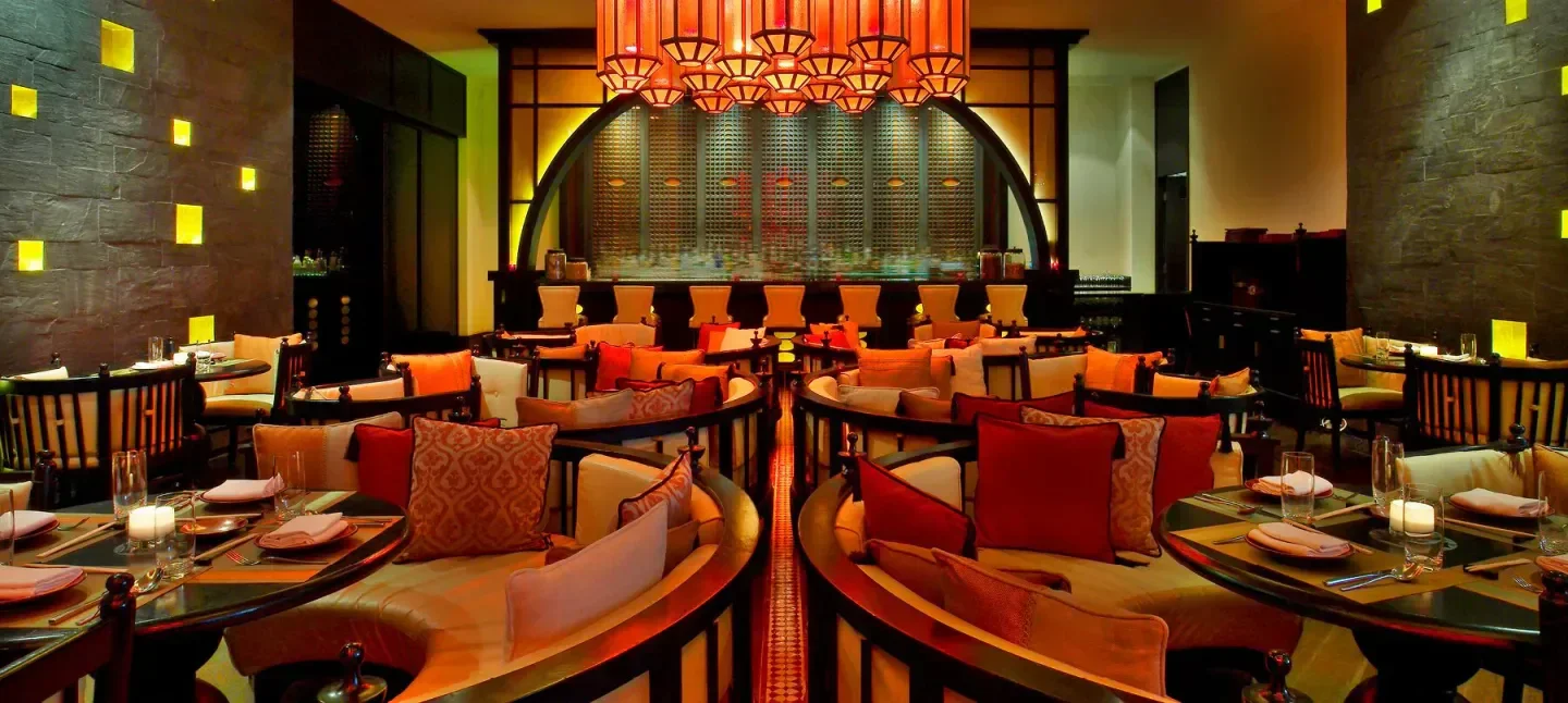 Cozy and stylish interior of Spice Market in Doha, with warm lighting and seating.