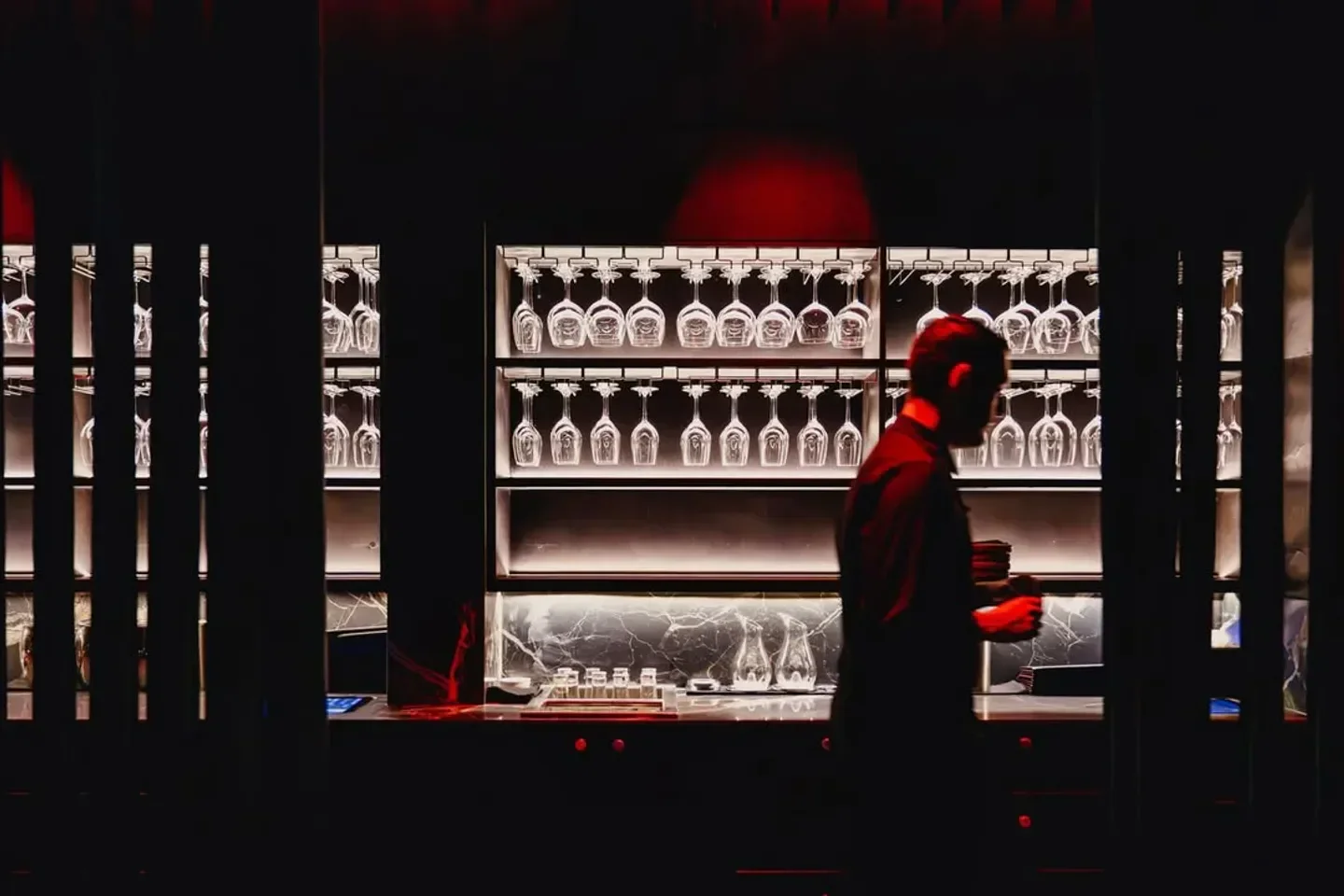 Interior of Spice Temple in Sydney with a sleek bar and hanging wine glasses