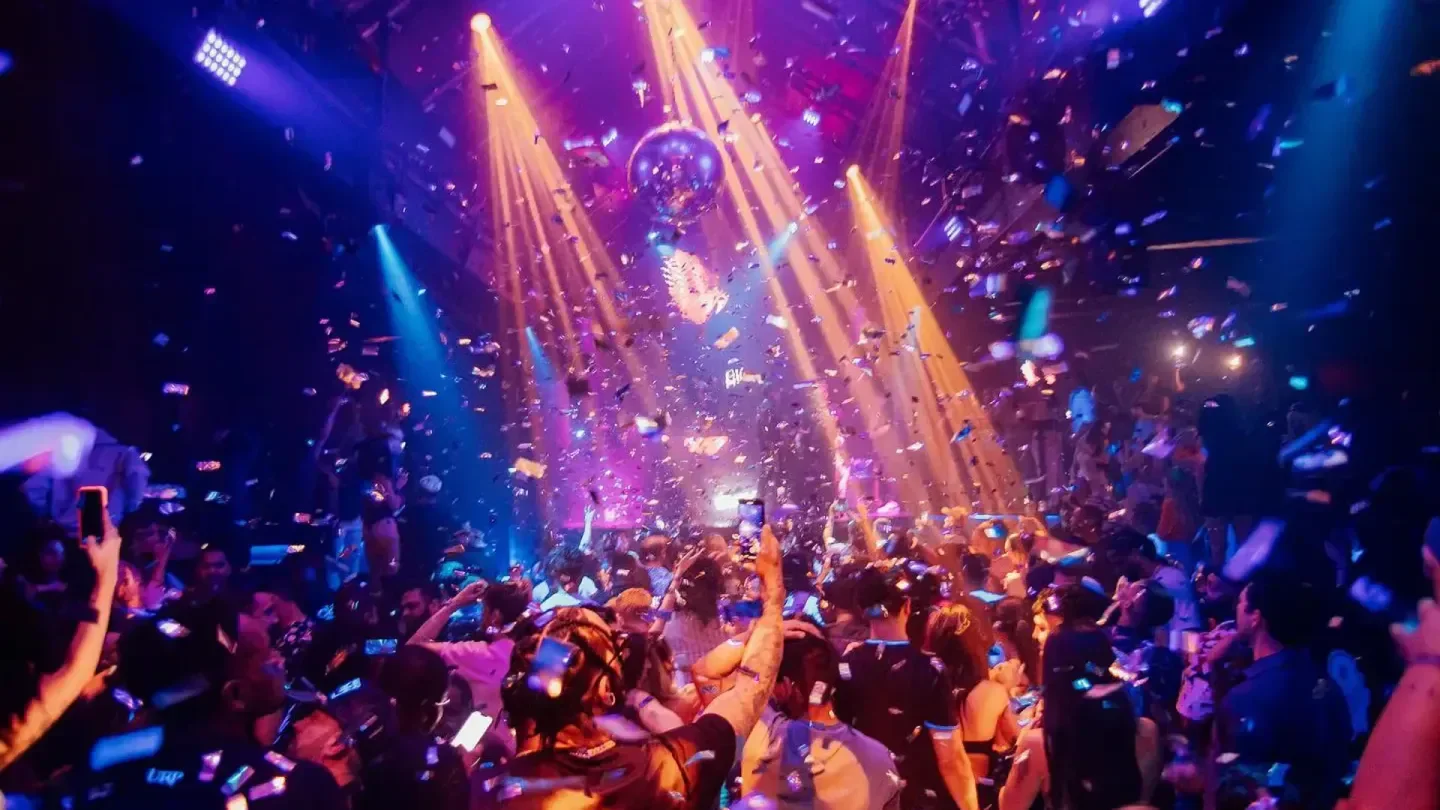 Confetti and lights at Spire nightclub in Houston, with a crowd of people partying.