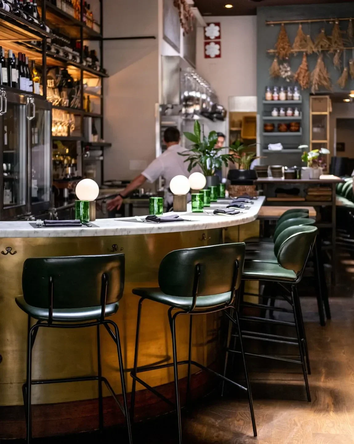 Elegant bar at SPQR restaurant in San Francisco with stylish green seating.