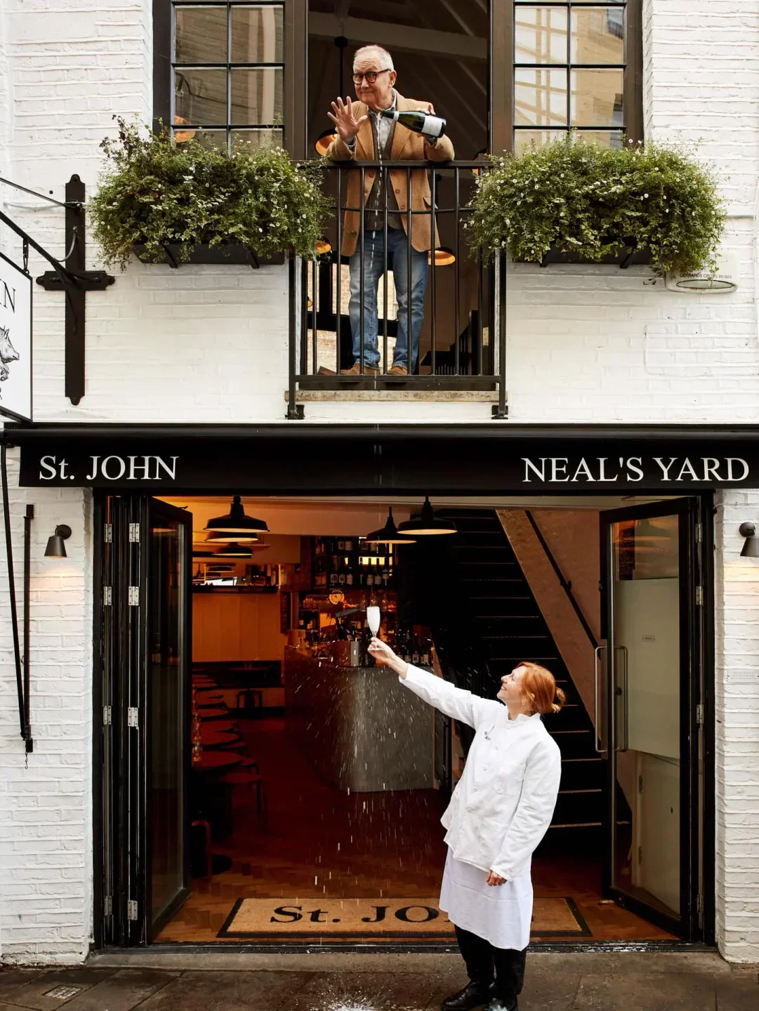 Celebration at St John restaurant in London: cheers with champagne on the balcony and doorway