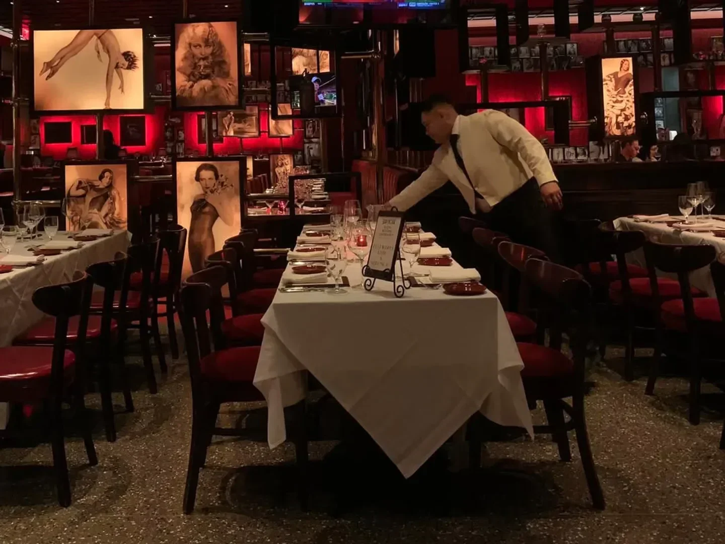Interior of Strip House - Las Vegas, featuring elegant dining tables and classic artwork in Las Vegas.