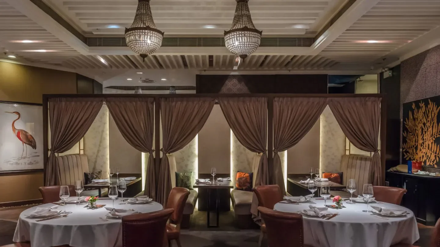 Elegant dining room at Sun Tung Lok, Hong Kong, with chandeliers and curtains.
