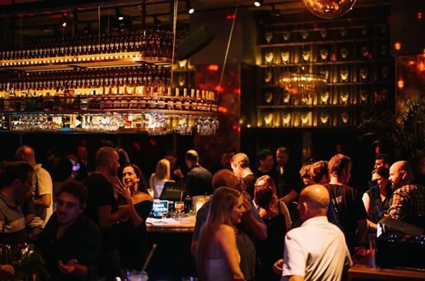 Busy nightlife scene at Supreme Room nightclub in Tel Aviv with stylish interior.
