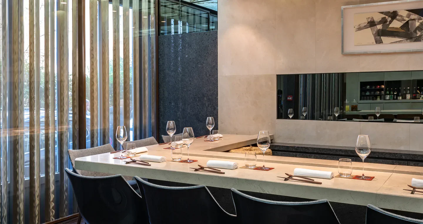 Elegant dining space at Sushi B in Paris, featuring modern design and sushi bar seating.