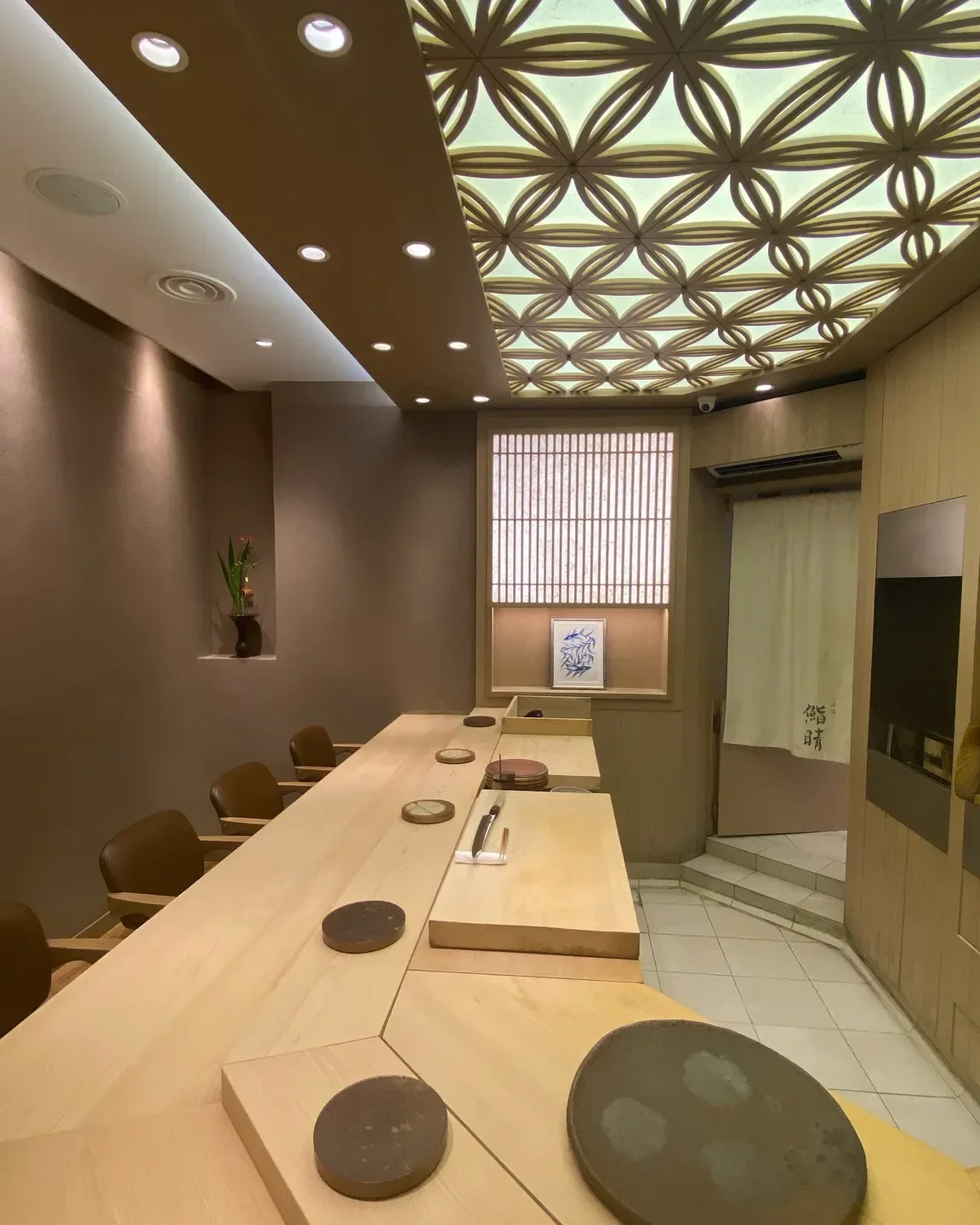 Interior of Sushi Haré in Hong Kong, featuring a minimalist sushi bar with overhead lighting.