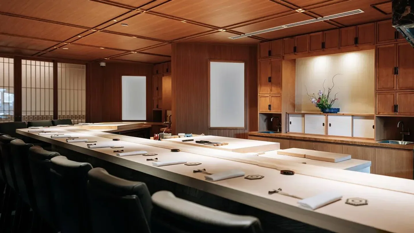 Interior of Sushi Masaki Saito in Toronto: wooden counter and dining area.