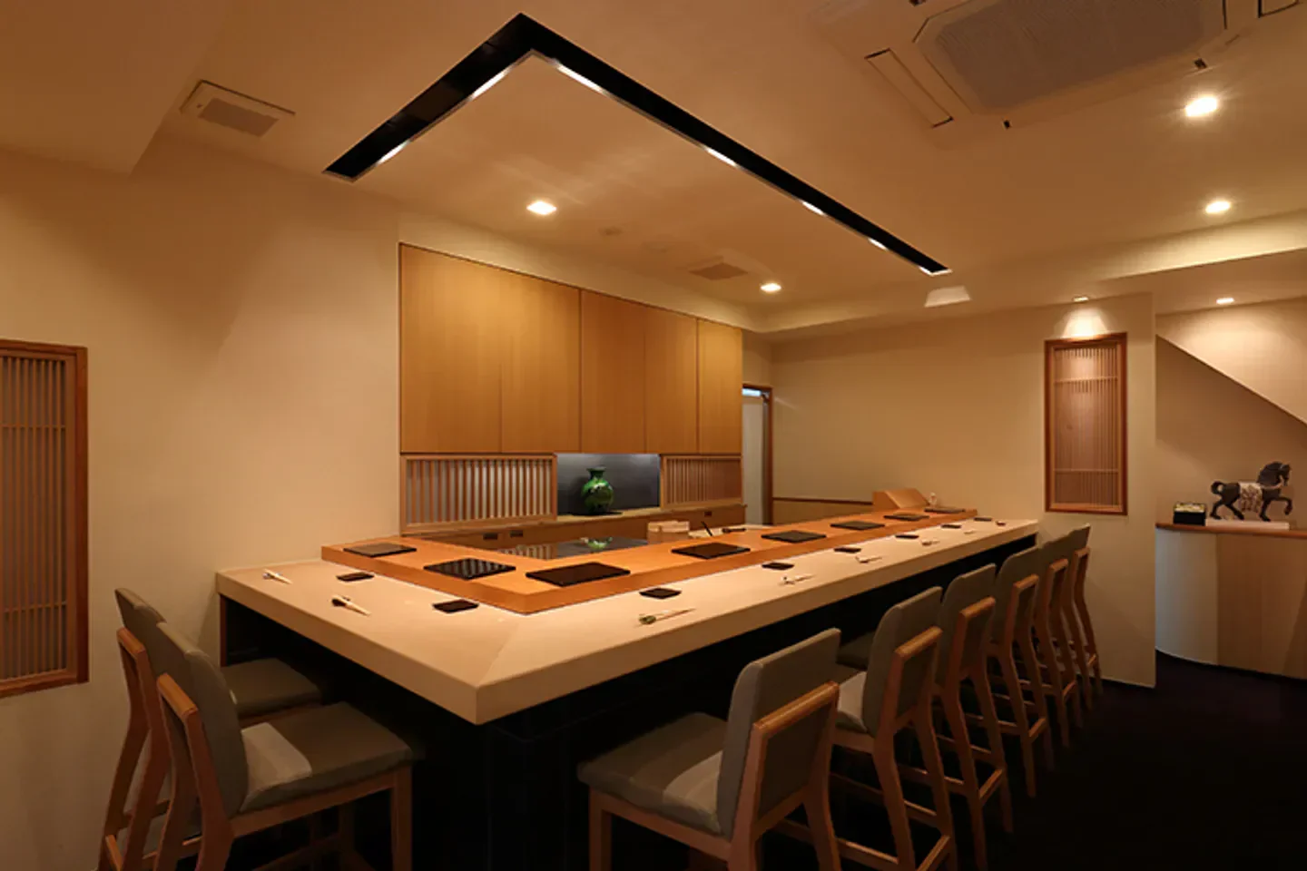 Interior view of Sushi Matsuura in Tokyo, featuring sushi bar and seating area.