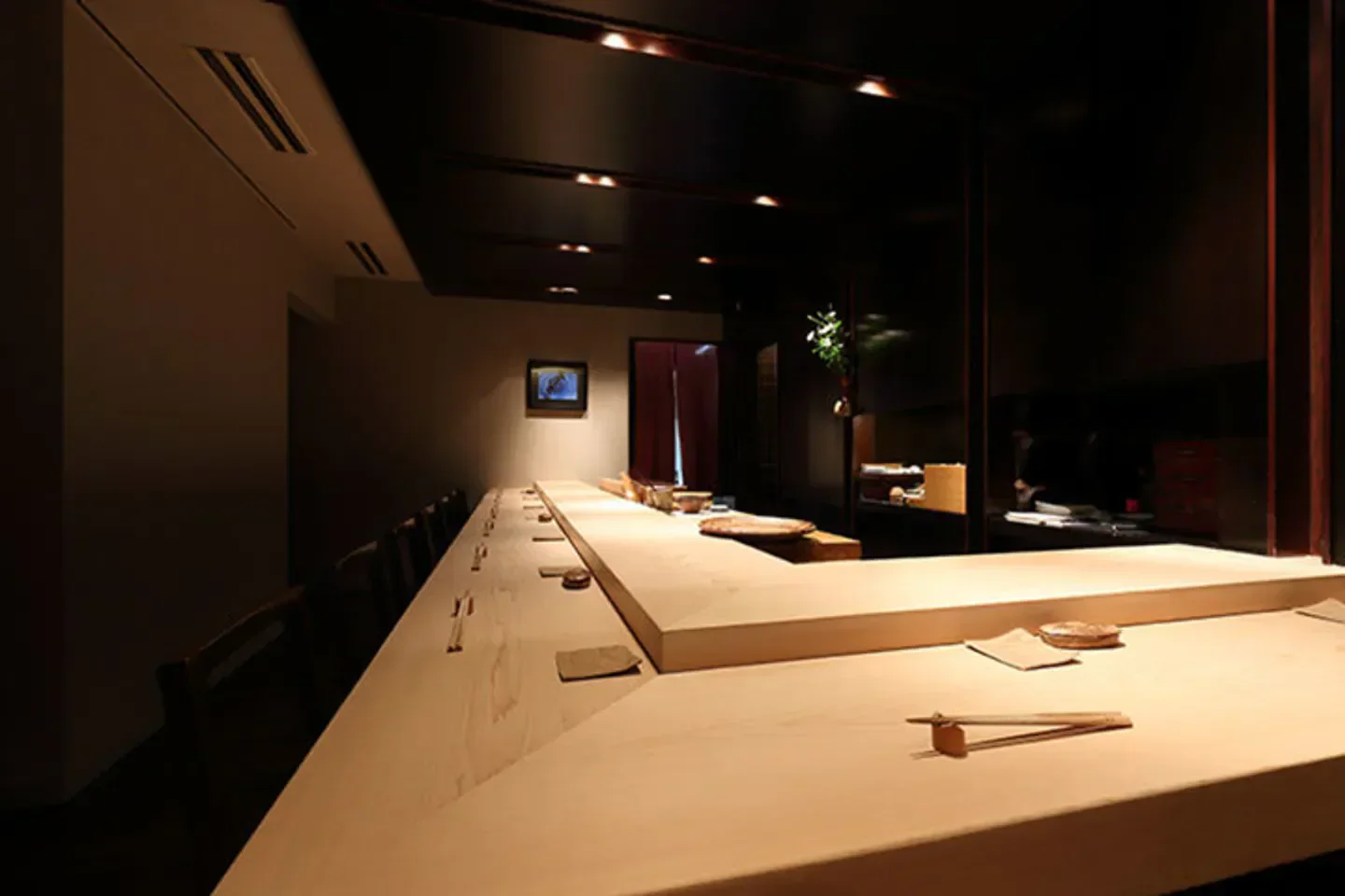 Interior of Sushidokoro Kiraku restaurant in Tokyo, showcasing a minimalist sushi bar.