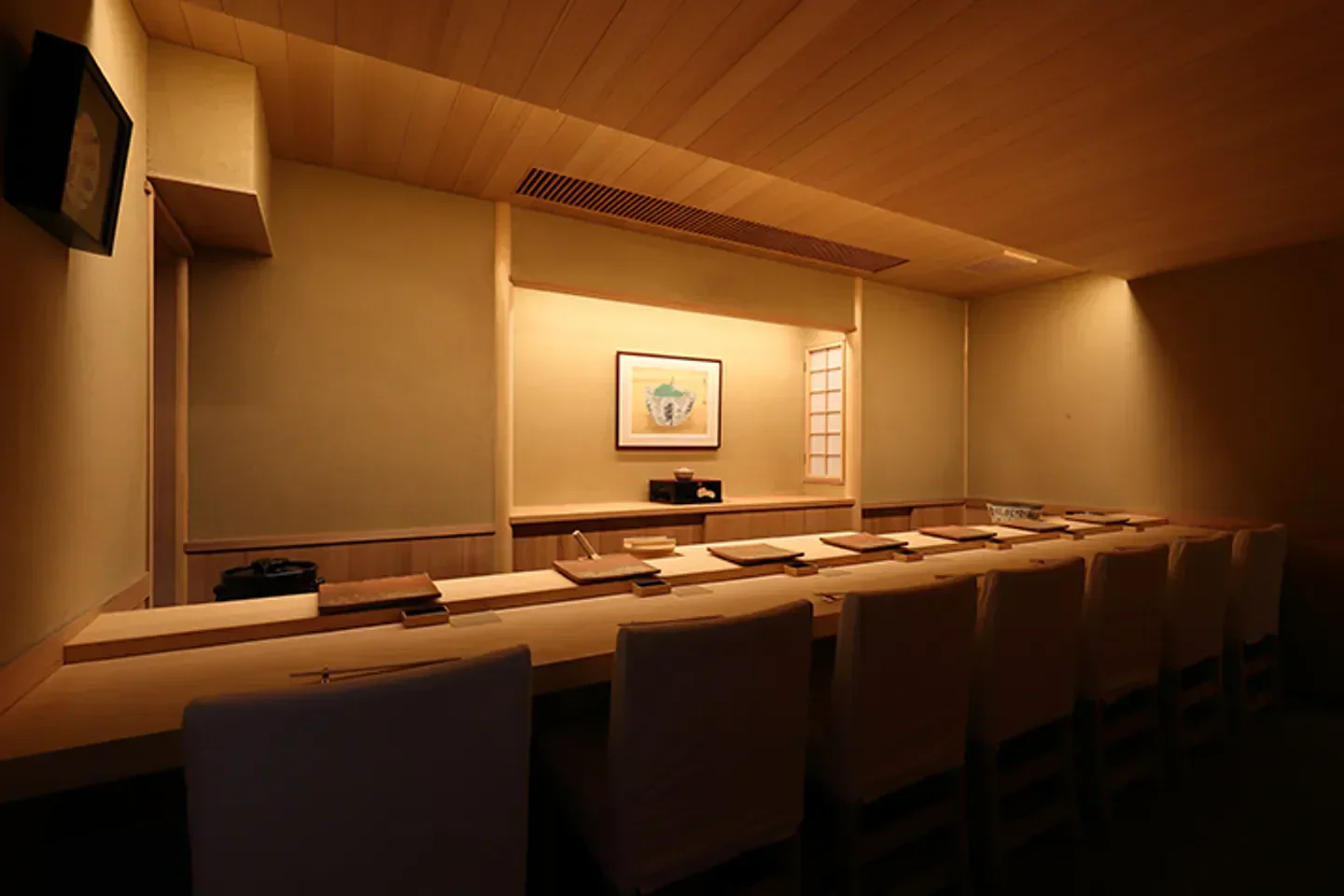 Interior of Sushiya Shota restaurant in Tokyo, showcasing a minimalist dining space.