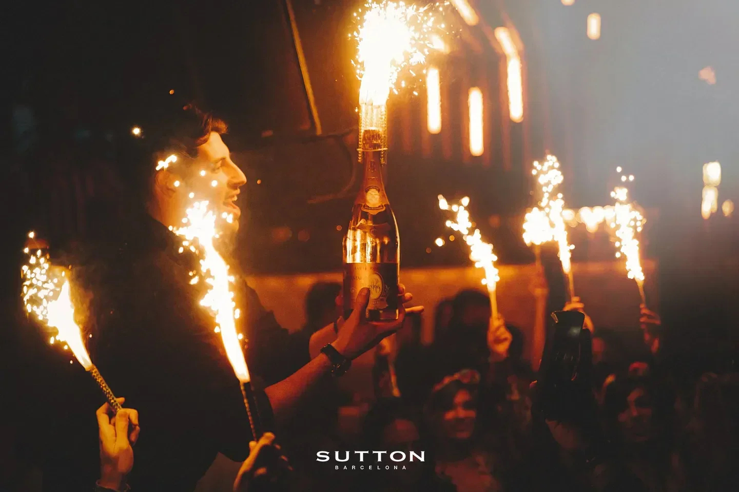 Sparkling celebration at Sutton Barcelona nightclub, a bottle of champagne with sparklers.