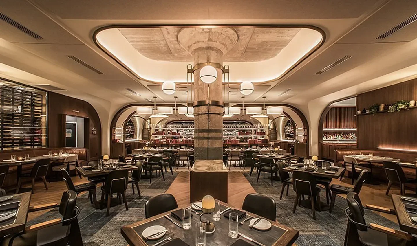 Elegant interior of Swift & Sons restaurant in Chicago, featuring stylish seating and lighting.