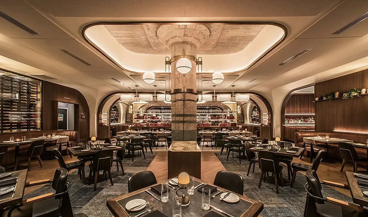 Elegant interior of Swift & Sons restaurant in Chicago, featuring stylish seating and lighting.