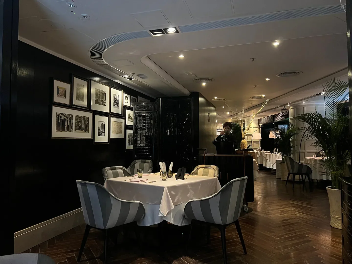 Interior dining at Ta Vie restaurant in Hong Kong, with art and elegant decor.