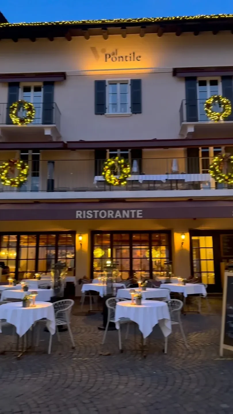 Exterior of Talvo by Dalsass restaurant in St. Moritz with outdoor seating and wreaths.