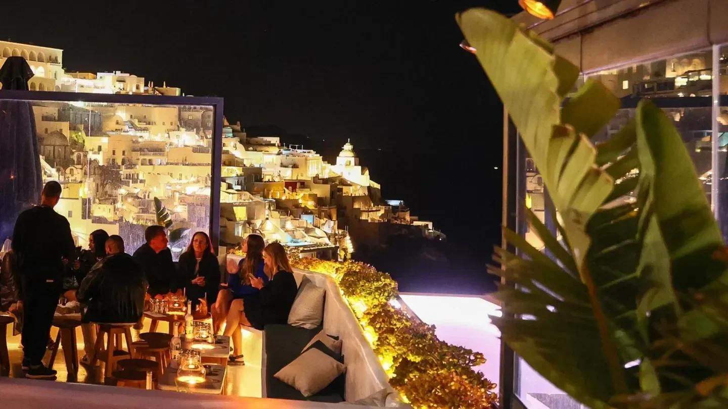 Tango nightclub in Santorini with beautiful city views at night, featuring people