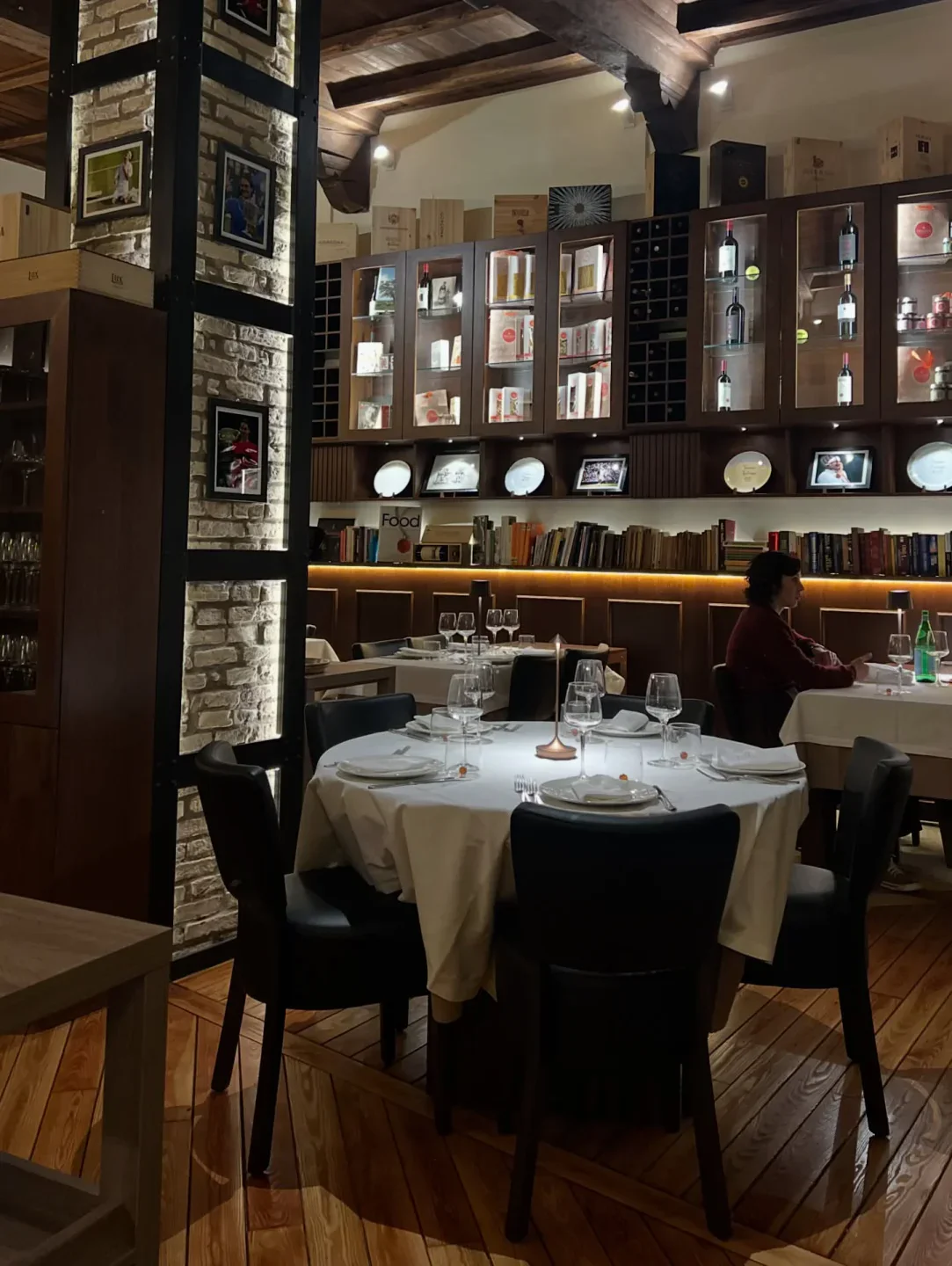 Taverna Trilussa in the city offers a cozy dining experience with elegant tables and wine displays.
