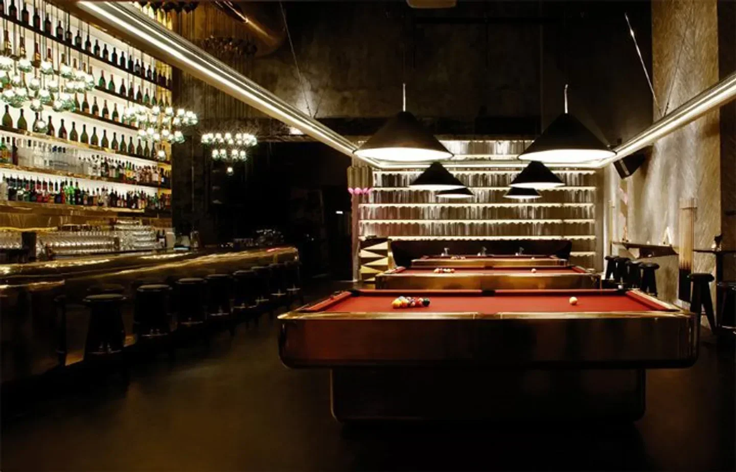Interior of Tazmania nightclub in Hong Kong featuring pool tables and a stylish bar area.