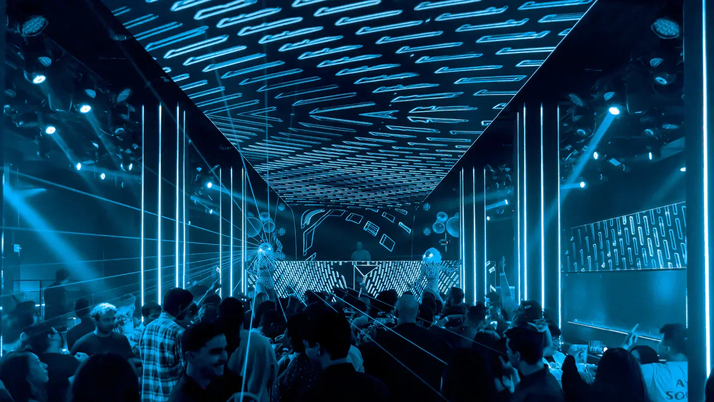 Inside Temple nightclub in San Francisco, with blue neon lights and a crowded dance floor.