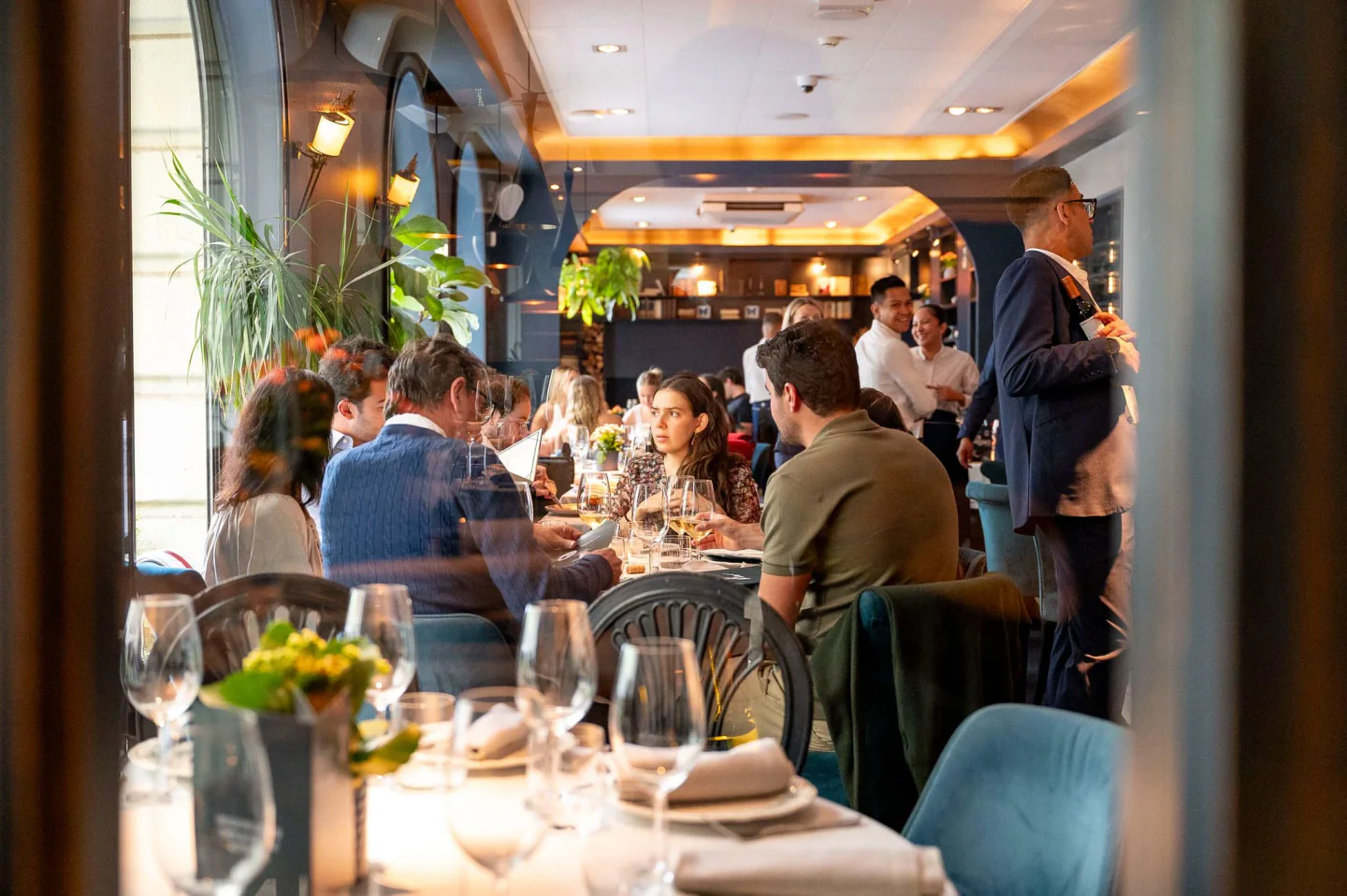 Ten Con Ten restaurant interior featuring elegantly set tables and diners enjoying a meal in the city.