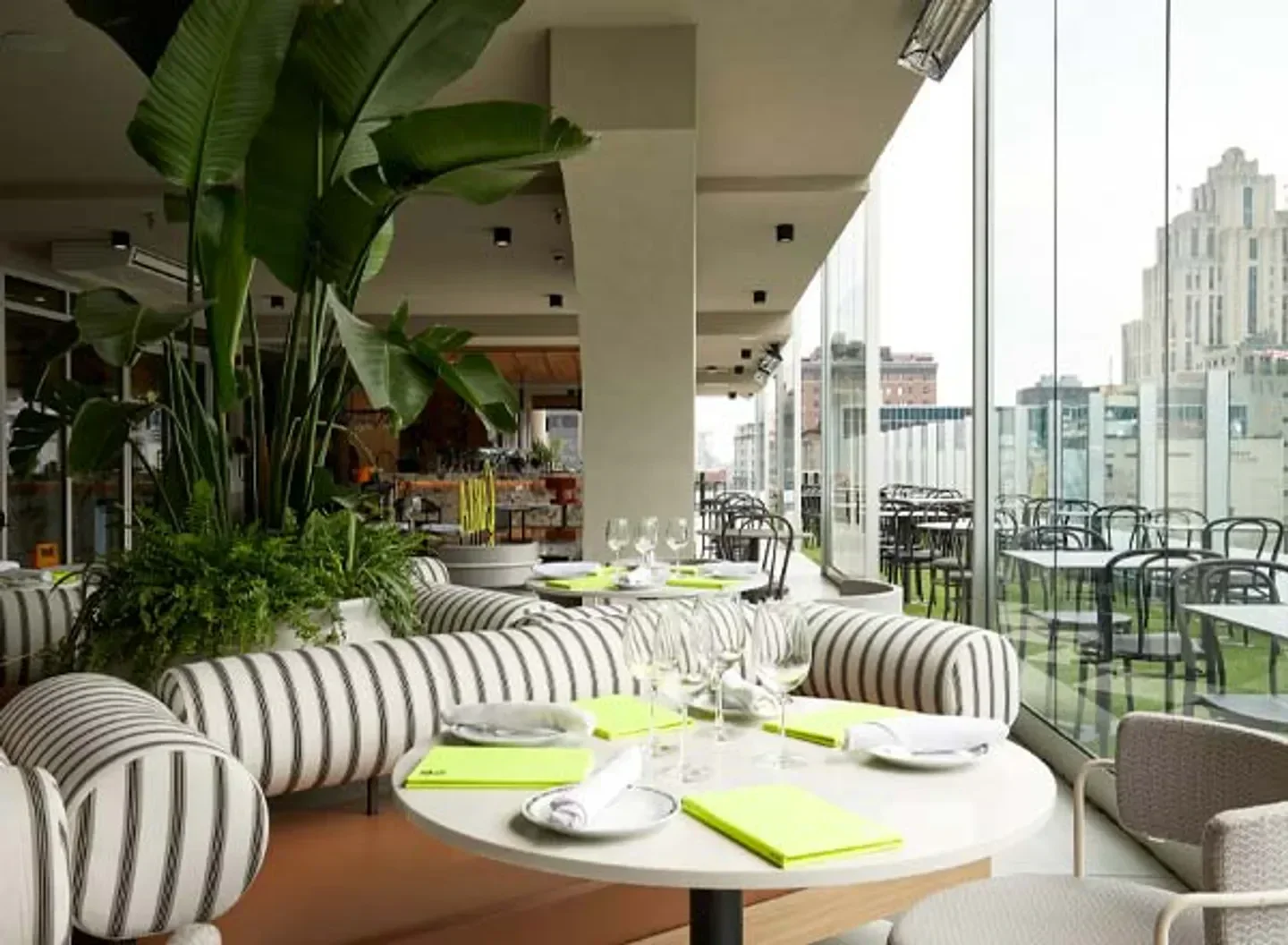 Stylish interior of Terrasse Carla restaurant in Montreal, with modern furniture and city views.
