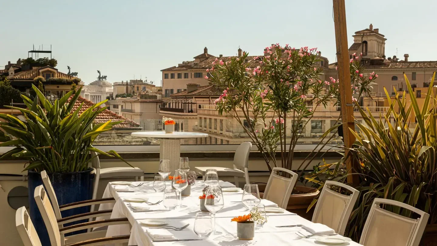 Terrazza Monti restaurant in Rome with a beautiful rooftop view and table setting