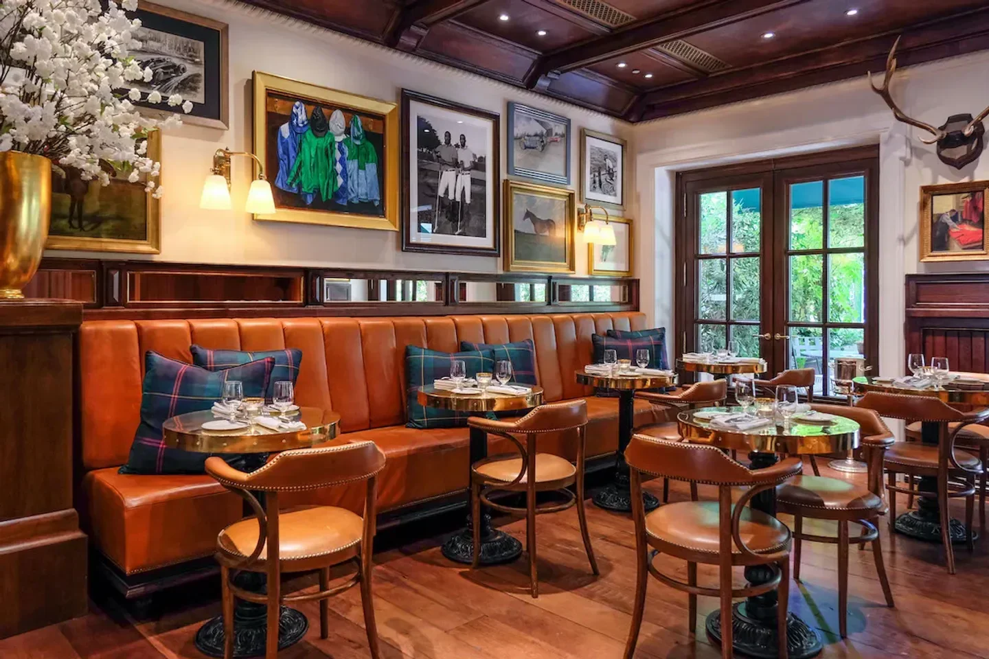 Cozy interior of The Bar at Ralph Lauren in Milan, with leather booths and art.