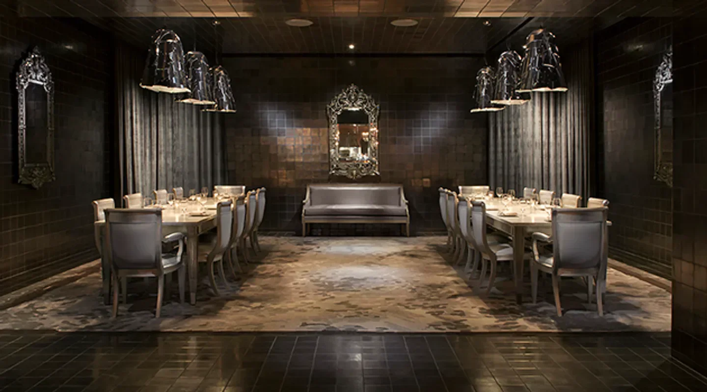 Elegant dining room at The Bazaar Meat by José Andrés in Las Vegas, with chandeliers.