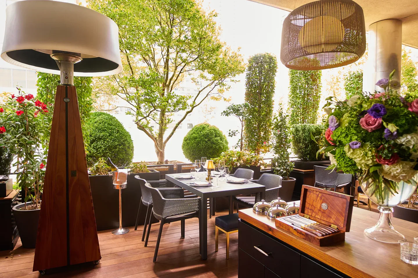 Outdoor dining at The Butcher Chef, Toronto, with elegant decor and lush greenery.