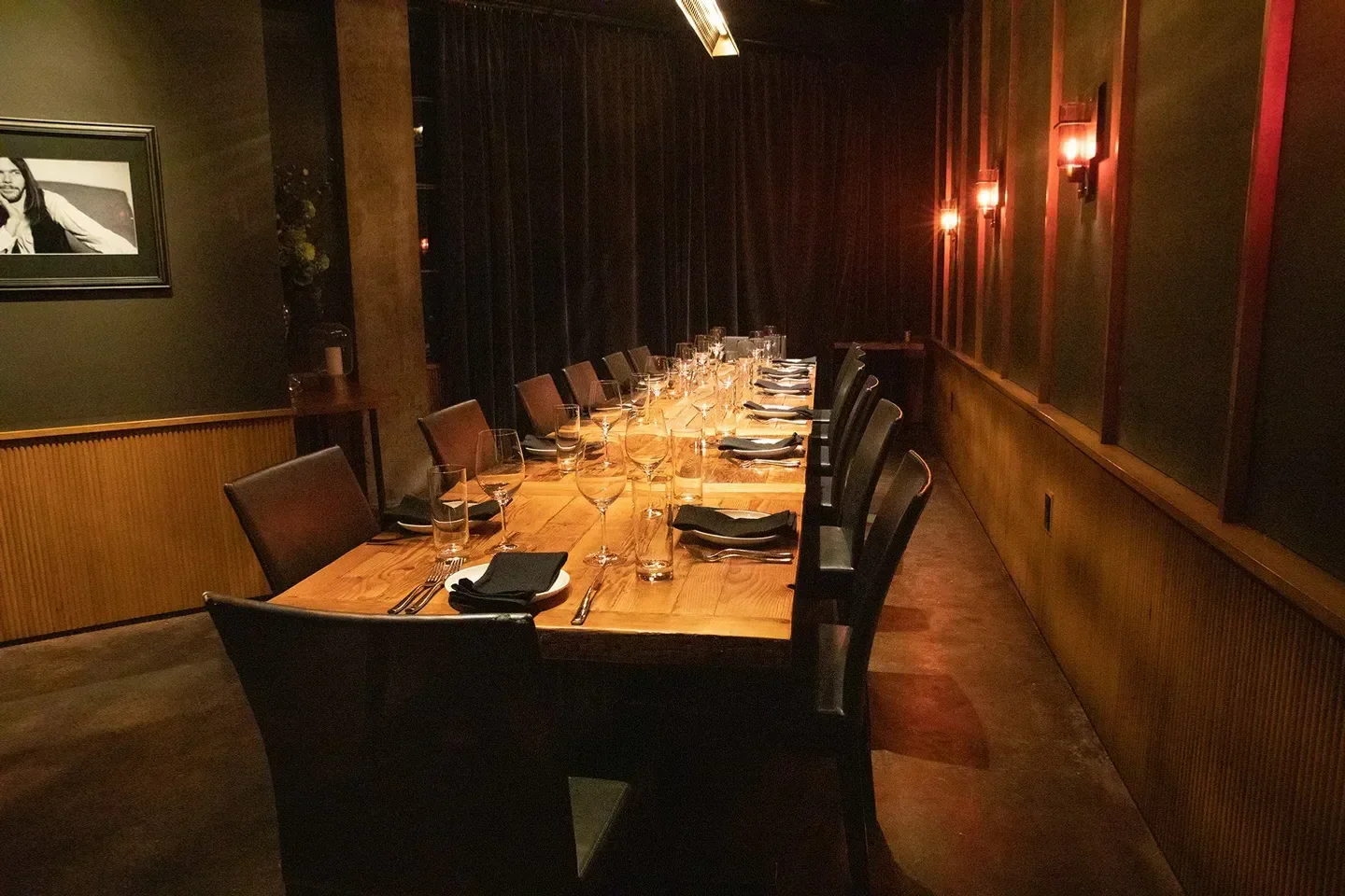 Interior of The Butcher's Table restaurant in Seattle, with a long dining table set.