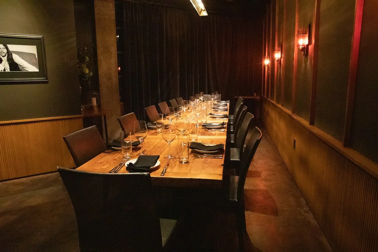 Interior of The Butcher's Table restaurant in Seattle, with a long dining table set.