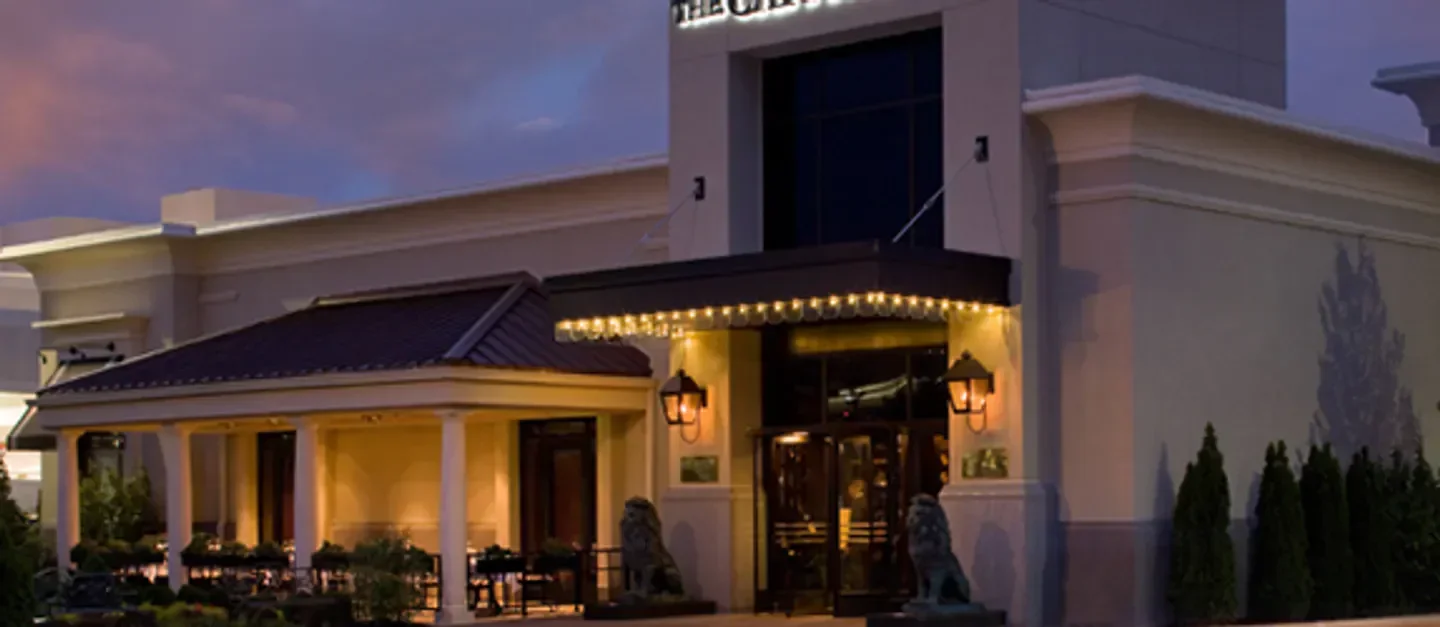 Exterior of The Capital Grille - Cherry Hill in Philadelphia at dusk with warm lighting.