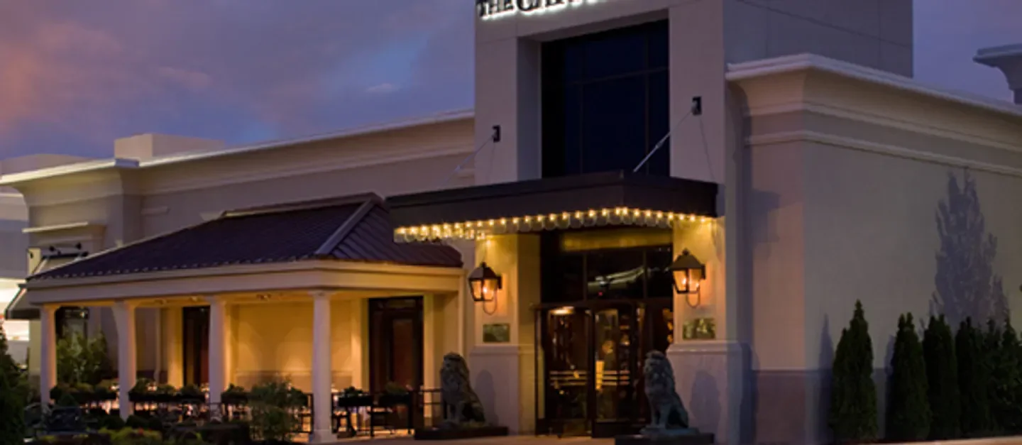 Exterior of The Capital Grille - Cherry Hill in Philadelphia at dusk with warm lighting.