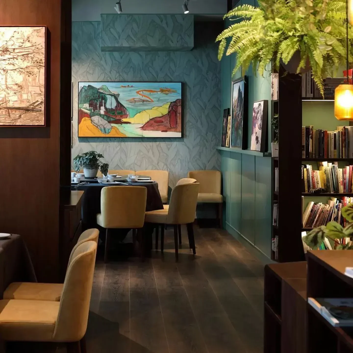 Cozy dining area at The Chairman restaurant in Hong Kong, with art and soft lighting.