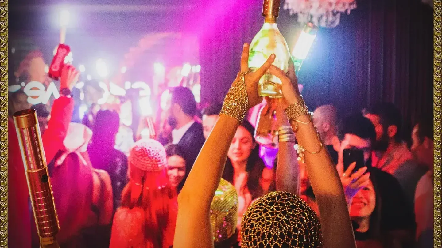 Champagne celebration at The Circus Club in Geneva. Party-goers enjoying a glamorous nightclub scene.